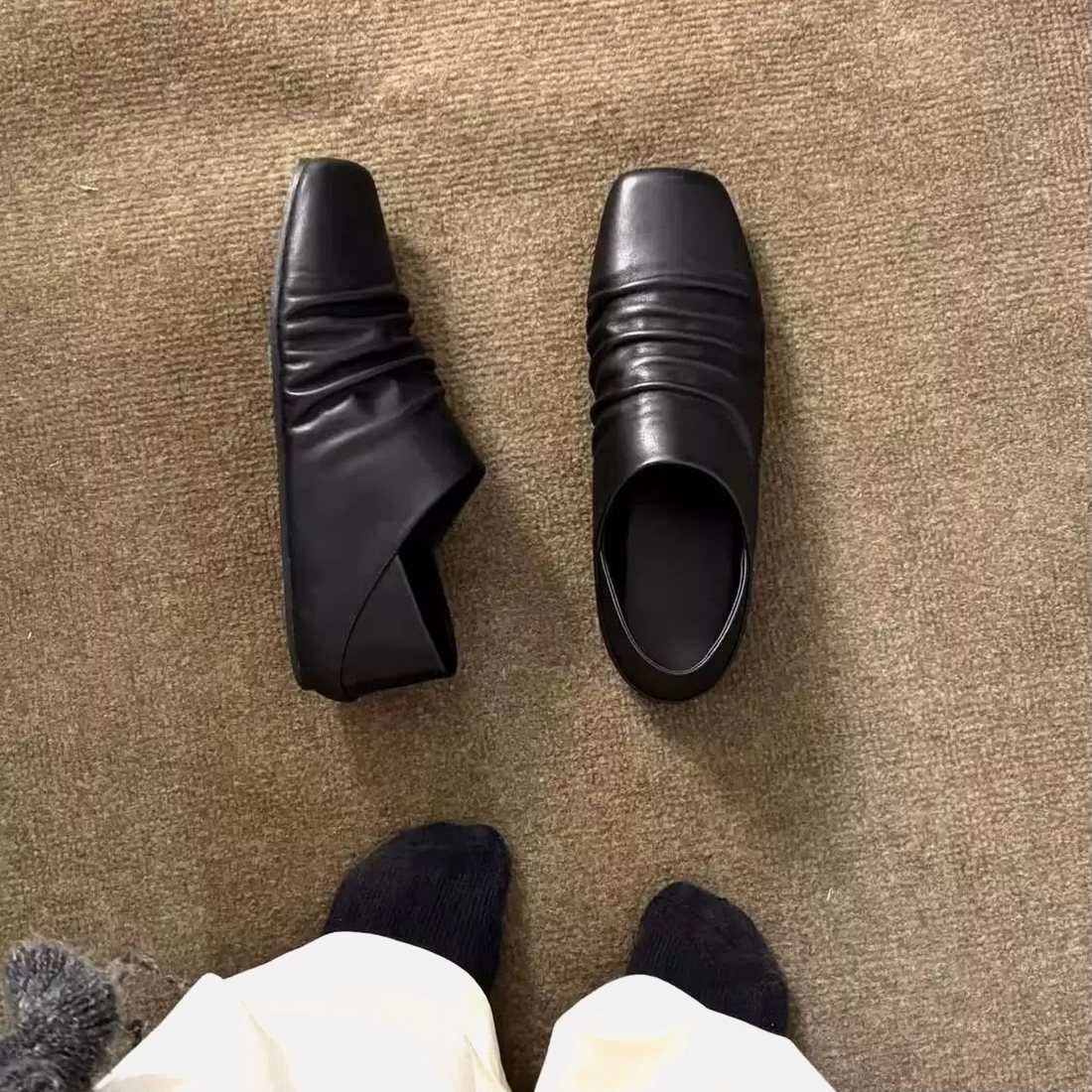 CREASED square-toe loafer, worn with black trousers